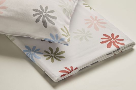 Bunt gemusterte Bettwäsche mit stilisierten Blumen in Blau, Grün, Rosa und Grau